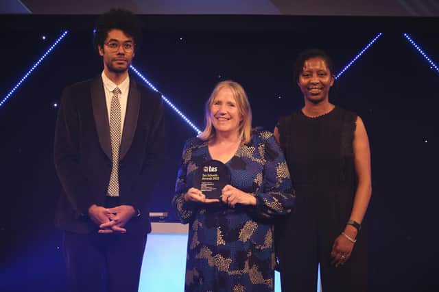 Gill Fitzpatrick, centre, receives her award from celebrity host Richard Ayoade and Amanda Wilson, headteacher at St Alfege with St Peter's CofE Primary School in London