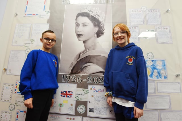 Pupils next to a display celebrating HRH Queen Elizabeth II