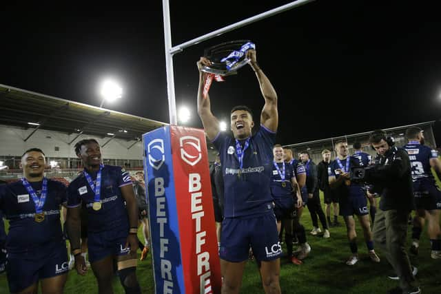 Wigan Warriors' Kai Pearce-Paul celebrates after the Leigh game with the League Leaders Shield