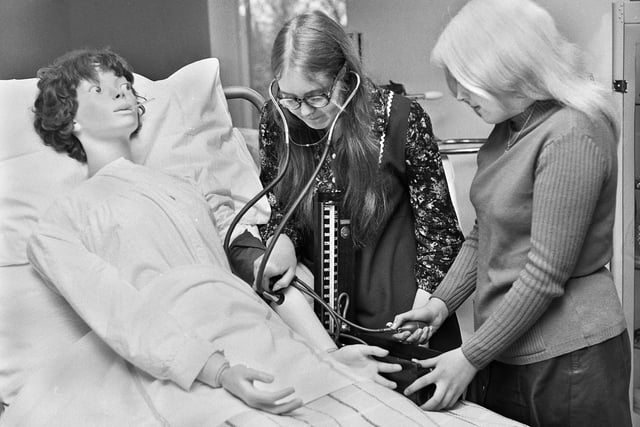 Pupil nurses, Susan Holgate and Eileen Holding, practise taking blood pressure on a model at the Wigan and Leigh School of Nursing at Billinge Hospital on Tuesday 29th of February 1972.
