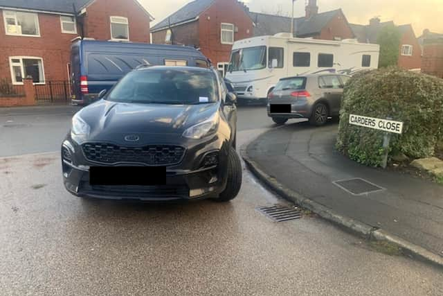 A car dangerously abandoned on a street corner