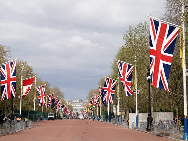Union flags hanging from the street furniture outside Buckingham Palace on the Mall, London