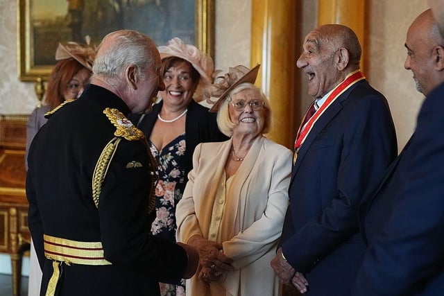 Rugby league star Billy Boston being knighted by King Charles III at Buckingham Palace