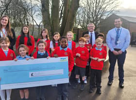 Councillors Laura Flynn and Chris Ready hand over a cheque to school council members