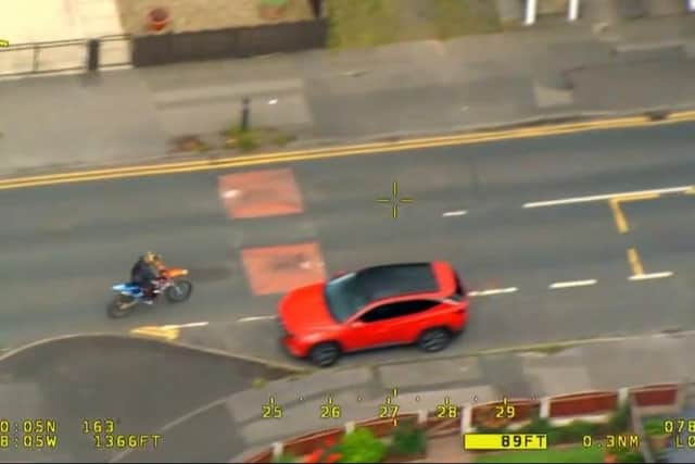 The reckless biker riding on the wrong side of the road