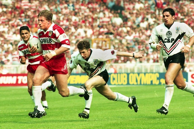 Denis Betts on the charge leaving Jonathan Davies floundering with Wigan on their way to beating Widnes 20-14 in the Challenge Cup Final at Wembley on Saturday 1st of May 1993.