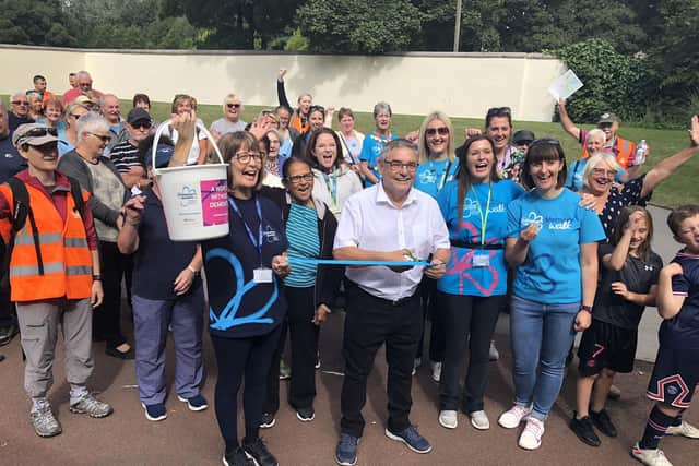 Coun Chris Ready (centre) and Pauline Blackie of Alzheimer's Society (holding bucket, front left) with fundraisers at last year's Pennington Hall Park Memory Walk