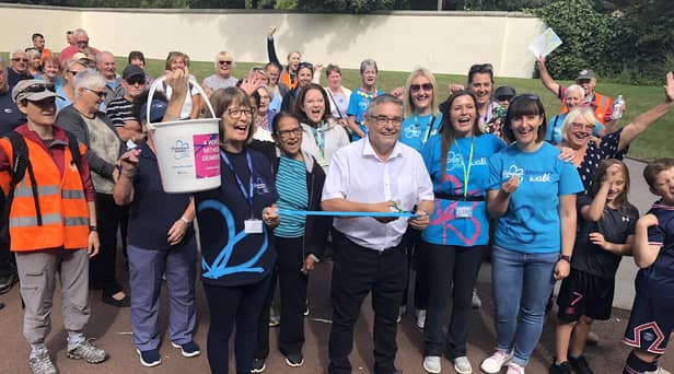 Coun Chris Ready (centre) and Pauline Blackie of Alzheimer's Society (holding bucket, front left) with fundraisers at last year's Pennington Hall Park Memory Walk