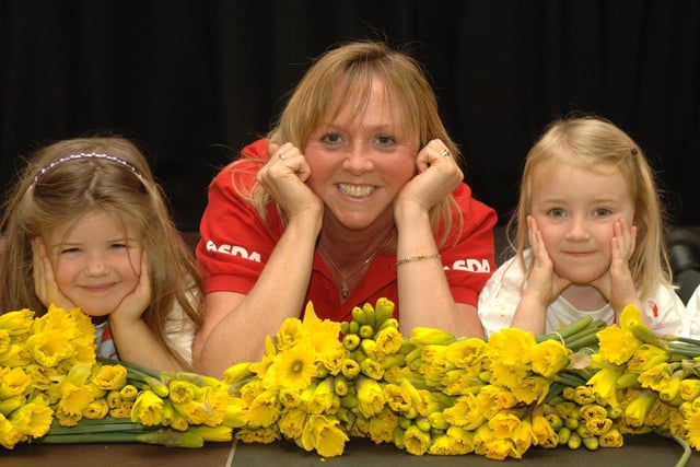 Bev Crossland, from Asda in Wigan, visited Woodfold Primary School in Standish to hand out daffodils to pupils Natasha and Lucy in celebration of Mother's Day