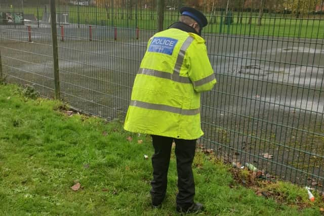 A police officer searching fields in Pemberton for knives during Operation Sceptre