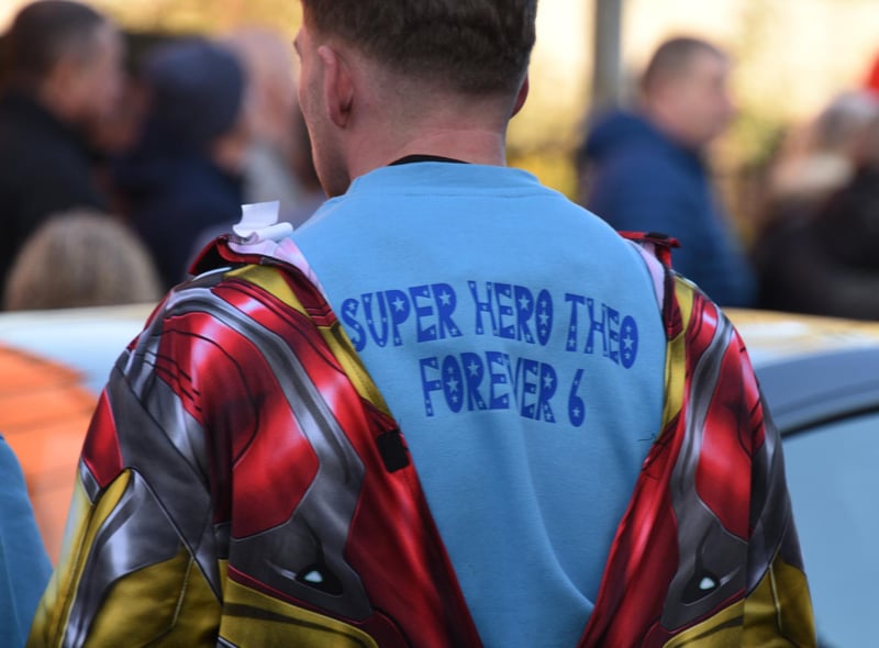 Some mourners wore superhero costumes or T-shirts featuring messages for Theo