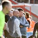 Exeter assistant boss Kevin Nicholson (second left, next to Gary Caldwell) has stoked the fire ahead of the second meeting against Latics in the space of a fortnight