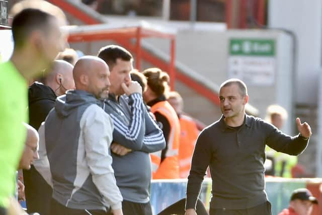 Exeter assistant boss Kevin Nicholson (second left, next to Gary Caldwell) has stoked the fire ahead of the second meeting against Latics in the space of a fortnight