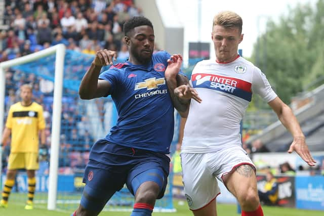 Tyler Blackett during his Manchester United days, getting stuck into Latics' Max Power during a friendly at the DW in 2016