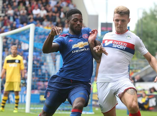Tyler Blackett during his Manchester United days, getting stuck into Latics' Max Power during a friendly at the DW in 2016