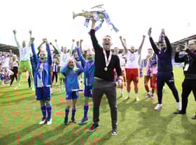 Leam Richardson lifts the League One title at Shrewsbury