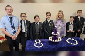 St Edmond Arrowsmith High School pupils who designed a special candleholder for the 80th anniversary of the liberation of Auschwitz. They are pictured with design technology teacher Stuart Morris and Jean Hensey-Reynard