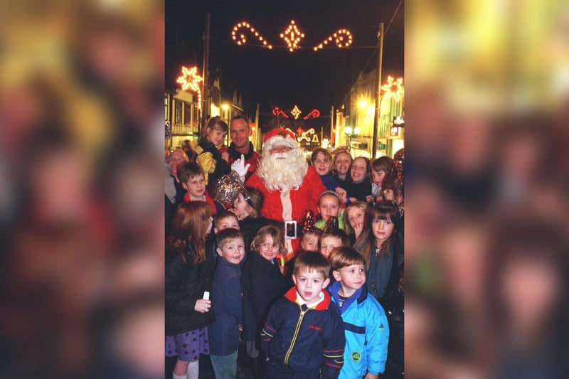 Santa surrounded by excited youngsters after switching on the Christmas lights in 1999