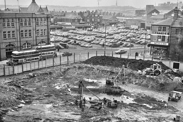 Excavations for the new Wigan Technical College under way affording a view through to the market square, the bus station and Hope Street in February 1969.
