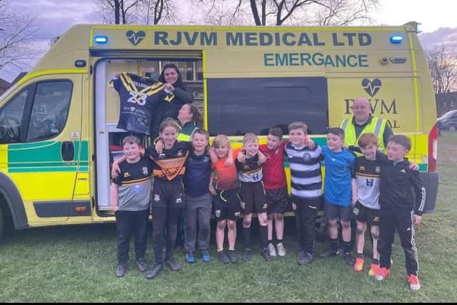 Wigan Bulldogs under-10s with the private ambulance that visited their training session