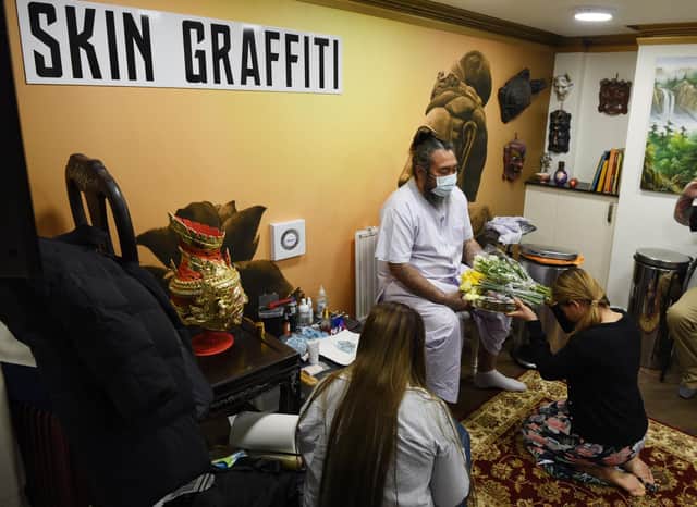 Skin Graffiti Tattoo Studio, Wigan, hosts Ajarn Ohr, a Sak Yant Master from Thailand, using traditional methods to create tattoos and blesses them.