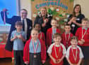 Councillors Chris Ready, Ron Conway and Laura Flynn hand out medals