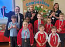 Councillors Chris Ready, Ron Conway and Laura Flynn hand out medals