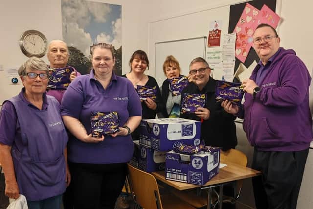 Coun Chris Ready hands over selection boxes to volunteers at The One House