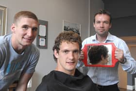 Wigan Warrior Sean O'Loughlin gets a trim at the opening of The Barbers, on Market Place, Wigan, with Sam Tomkins and barber Paul Tierney