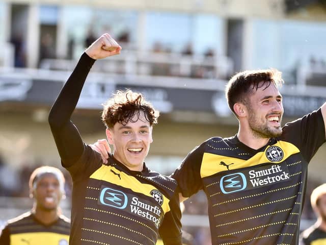 Luke Chambers (left) celebrates scoring at Bristol Rovers with James Carragher