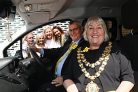 Mayor of Wigan Coun Marie Morgan in the new van with consort Coun Clive Morgan and the team at Daffodils Dreams