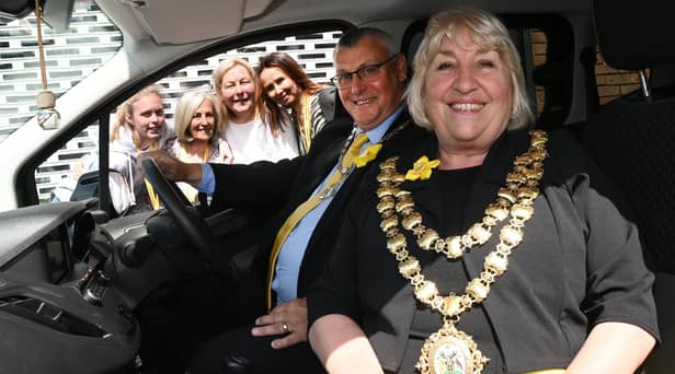 Mayor of Wigan Coun Marie Morgan in the new van with consort Coun Clive Morgan and the team at Daffodils Dreams