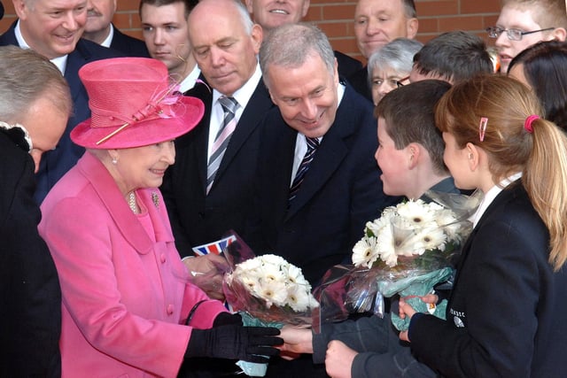 Ethan Kelly from Hope School and Demi Reed from Pembec High School present flowers to the Queen.