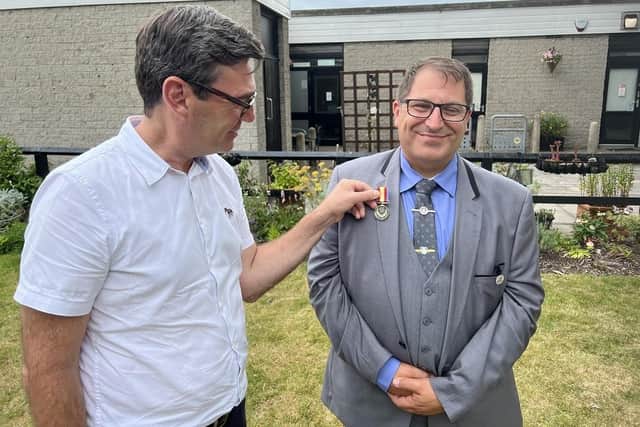 Greater Manchester mayor Andy Burnham presents the Nuclear Test Veterans Medal to Martin Blackburn on behalf of Martin's dad Norman at Golborne Library