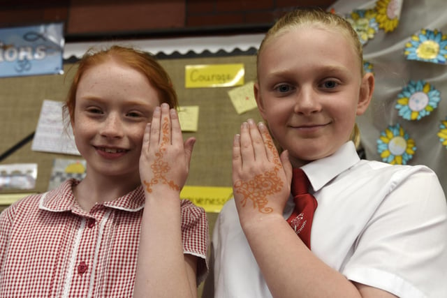 Pupils try the craft of henna on their hands.