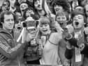 Wigan Athletic goalkeeper John Brown shows his Player of the Year trophy to fans  before the match against Halifax Town at Springfield Park in the Division 4 fixture on Saturday 12th of April 1980. 
Latics won the match 3-1 with Neil Davids, Peter Houghton and Mick Quinn getting the goals.
