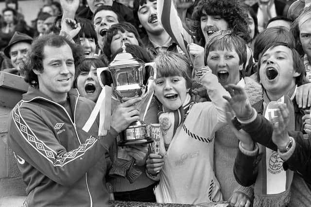 Wigan Athletic goalkeeper John Brown shows his Player of the Year trophy to fans  before the match against Halifax Town at Springfield Park in the Division 4 fixture on Saturday 12th of April 1980. 
Latics won the match 3-1 with Neil Davids, Peter Houghton and Mick Quinn getting the goals.