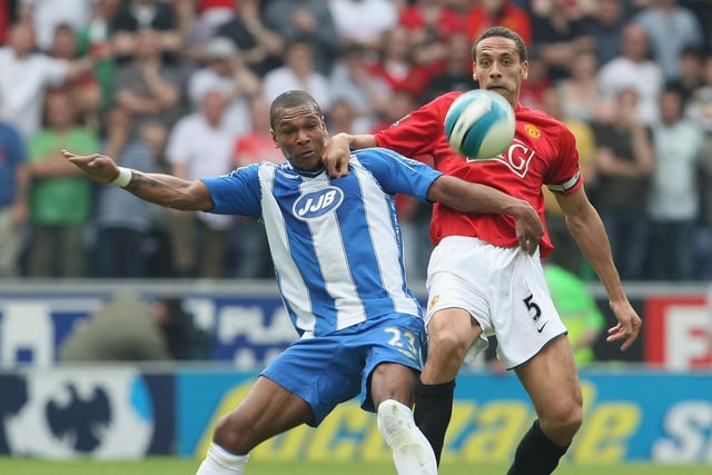 Rio Ferdinand of Manchester United clashes with Marcus Bent of Wigan Athletic during the Barclays FA Premier League match between Wigan Athletic and Manchester United at JJB Stadium on May 11 2008, in Wigan, England.