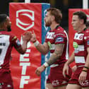 Adam Keighran (centre) celebrating a try with his Wigan Warriors teammates