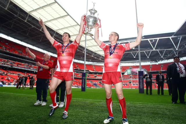 Joel Tomkins and Sam Tomkins celebrate winning the Challenge Cup in 2011