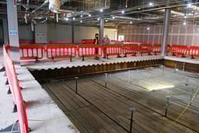 A large rectangular hole has been cut in the upper floor of the former Debenhams. At the moment dropboards, otherwise known as a crash deck, are in place to stop debris falling to the ground. Soon they will be removed