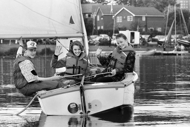 Young enthusiasts Sarah Winnard and Kathy McMahon enjoying an outing on Scotman's Flash with David Bright at the helm during an Open Day at Wigan Sailing Club in Poolstock on Bank Holiday Monday May 1991.