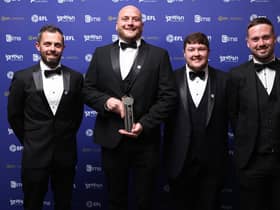 The Latics delegation celebrate with their award
