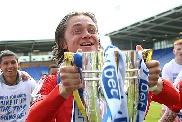 Thelo Aasgaard celebrates on the pitch at Shrewsbury
