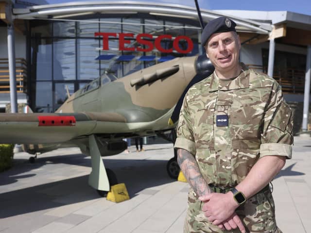 Anthony Morris (RAF Reserves) stands in front of an RAF Hurricane at the entrance to Tesco head office. Military chefs took part in a live cook off, hosted by the supermarket chain, to mark Armed Forces Week.