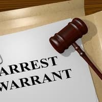 An arrest warrant is issued for a Wigan woman accused of strangulation following a court no-show