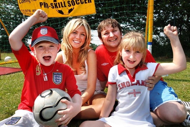 Liverpool star Peter Crouch's girlfriend, Abigail Clancy, joins in the support for England in that year's World Cup with Paul Platt, daughter Rebecca and Liam Roach after opening the St. Teresa's Primary School Summer Fayre in Up Holland on Saturday 1st of July 2006. 