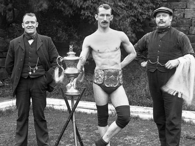 Champion Wigan wrestler, Bob Berry, with manager, Will Bennet, left, and trainer J. Stockley in the early 1900s.