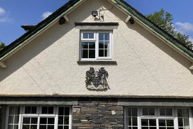 Wigan's coat of arms on the side of the Low Bank Ground building in Coniston