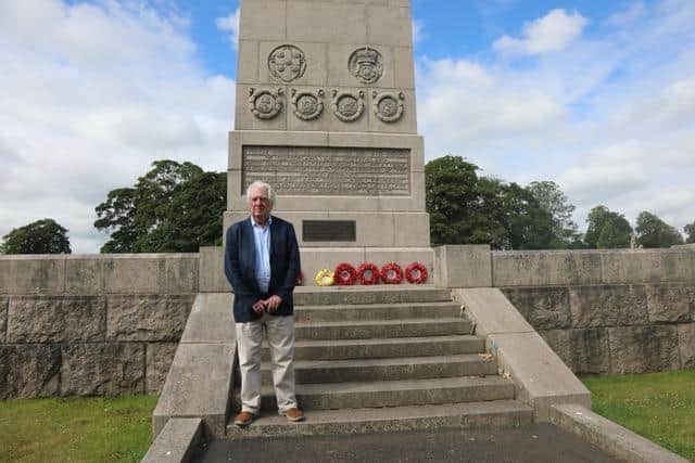 Eric Martlew pictured at the war memorial in Carlisle with a yellow wreath laid to honour the Canary Girls.